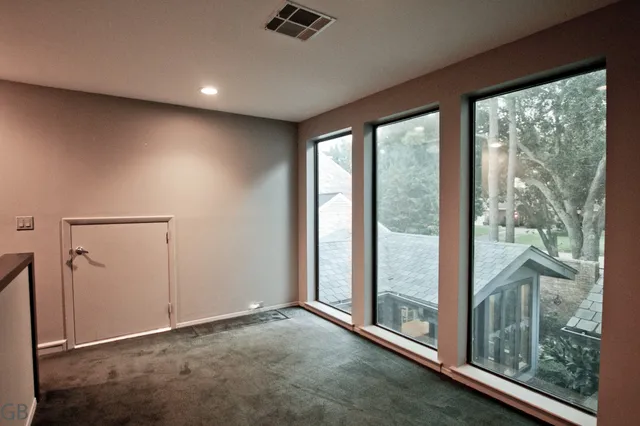 a view of a room with wooden floor and furniture