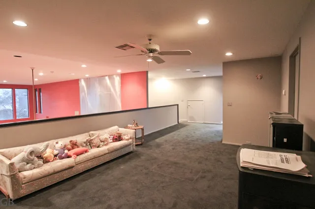 a view of a livingroom with a ceiling fan and window