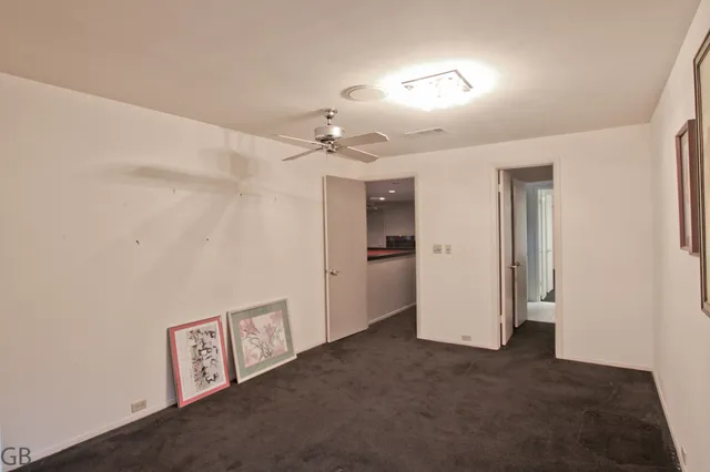 a view of an empty room with a fan