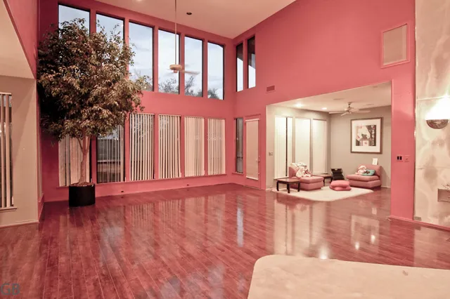 a dining room with wooden floor and furniture
