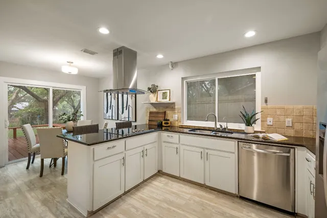 a kitchen with stainless steel appliances granite countertop a sink and stove