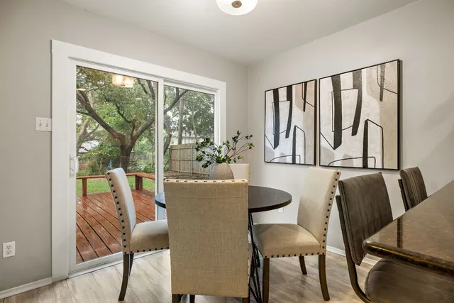 a dining room with furniture window and wooden floor