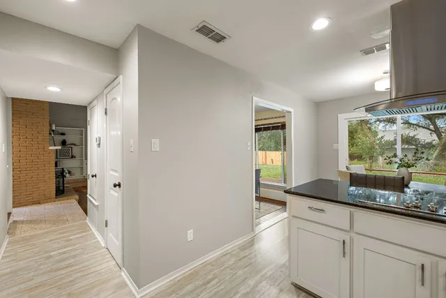 a kitchen with granite countertop a refrigerator and a sink
