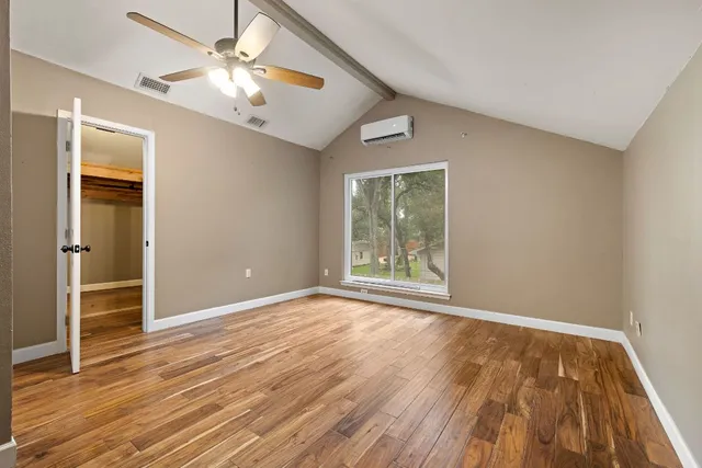 wooden floor in an empty room with a window