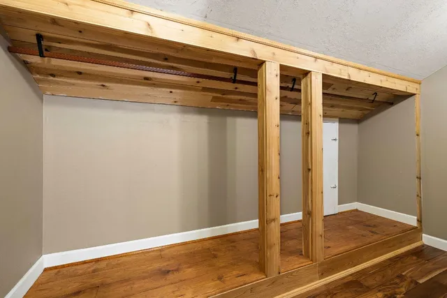 a view of a room with wooden floor and staircase