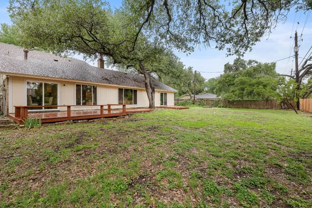 a white house that has a tree in front of it