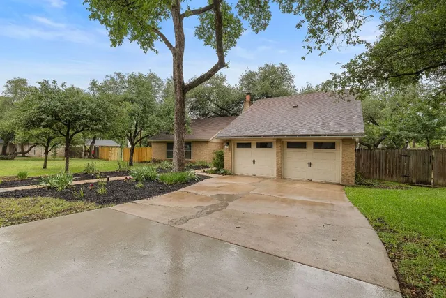 a view of a house with a yard and tree s