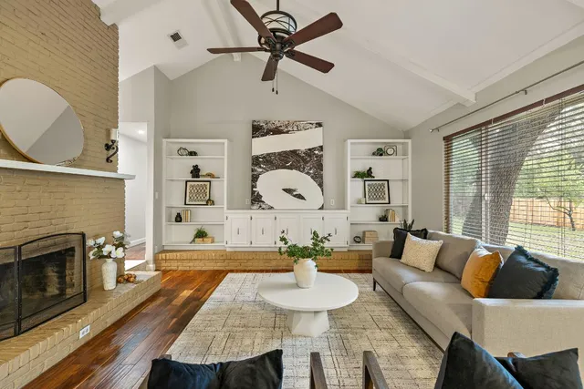 a living room with furniture and a fireplace