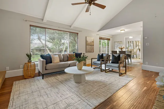 a living room with fireplace furniture and a large window