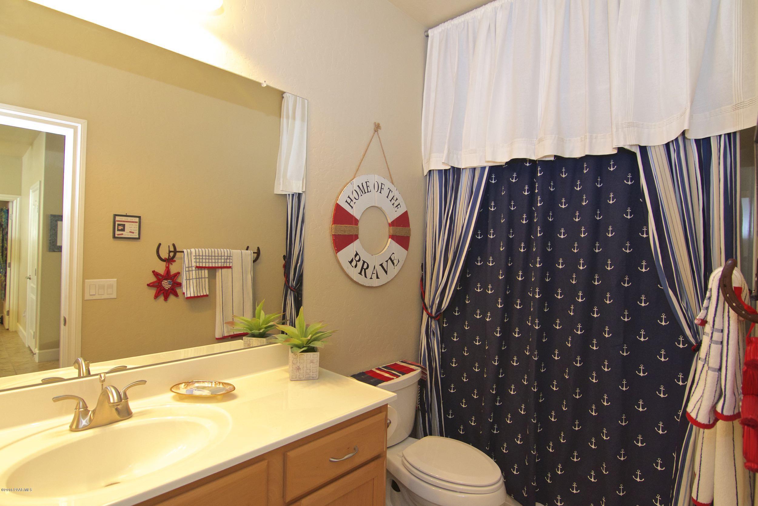 1157 Rusty Nail Road Prescott Valley, AZ 86314 - Photo 12 of 45 a bathroom with a sink toilet and shower