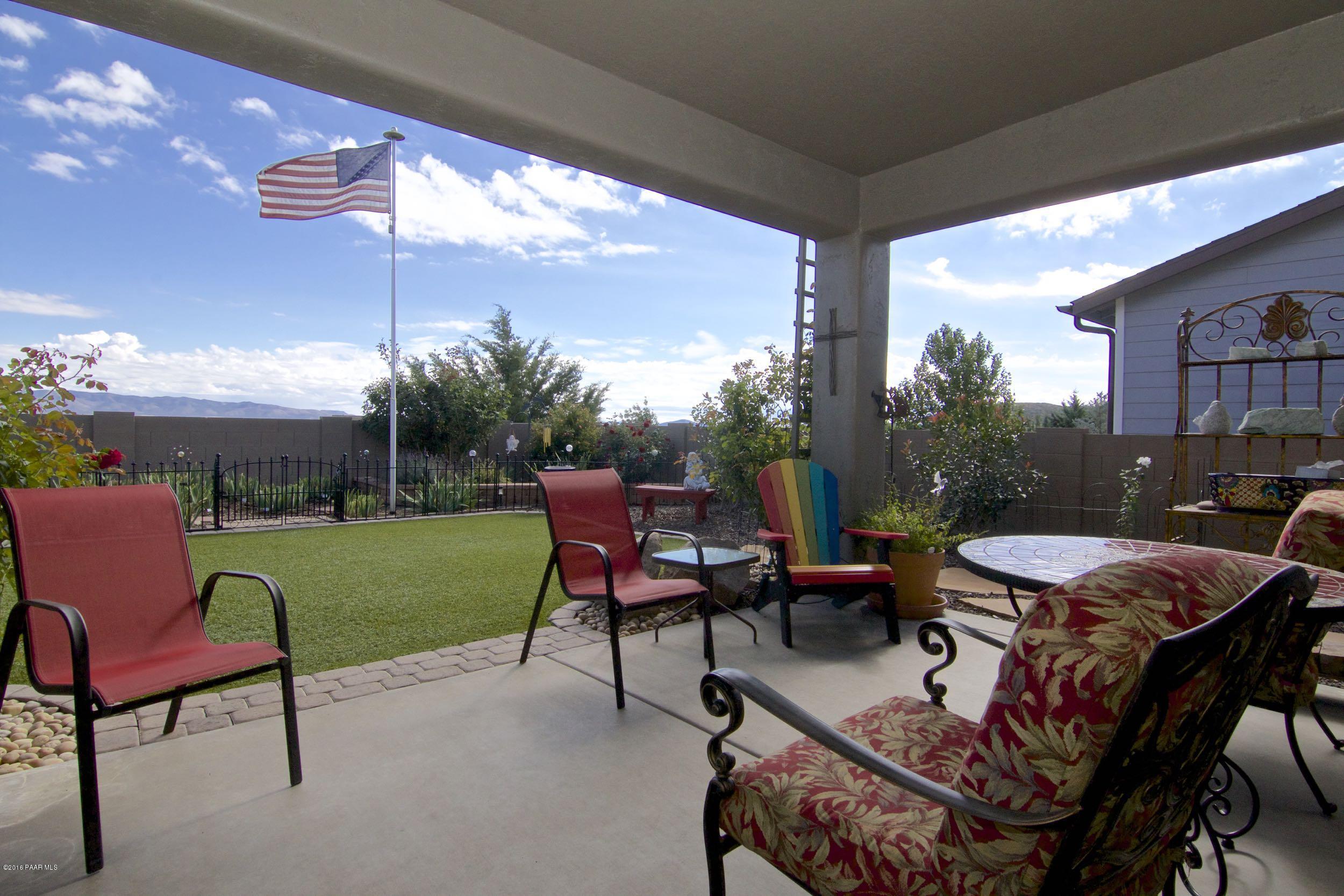 1157 Rusty Nail Road Prescott Valley, AZ 86314 - Photo 23 of 45 a view of a patio with chair and table