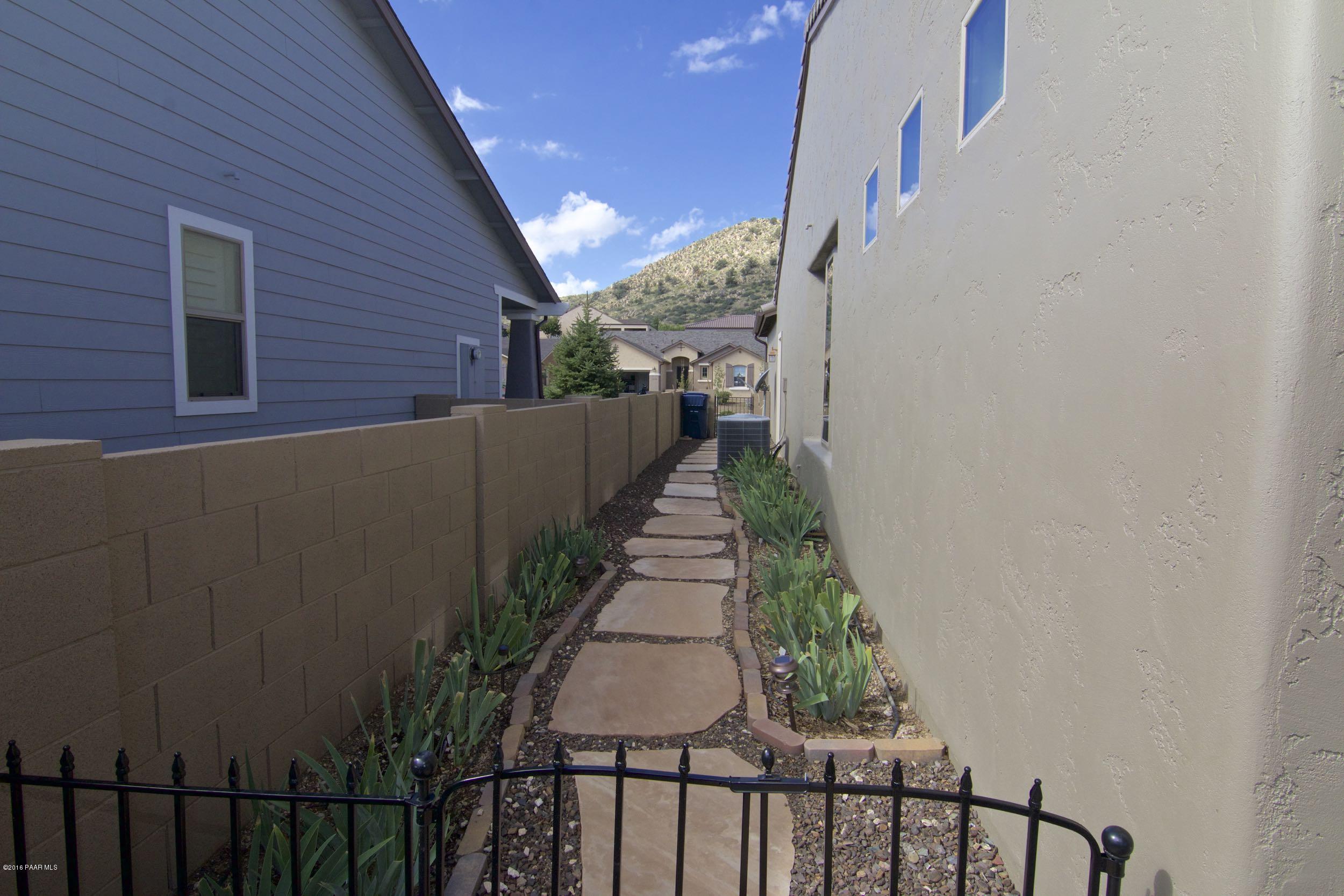 1157 Rusty Nail Road Prescott Valley, AZ 86314 - Photo 24 of 45 a view of a pathway of a house with wooden fence