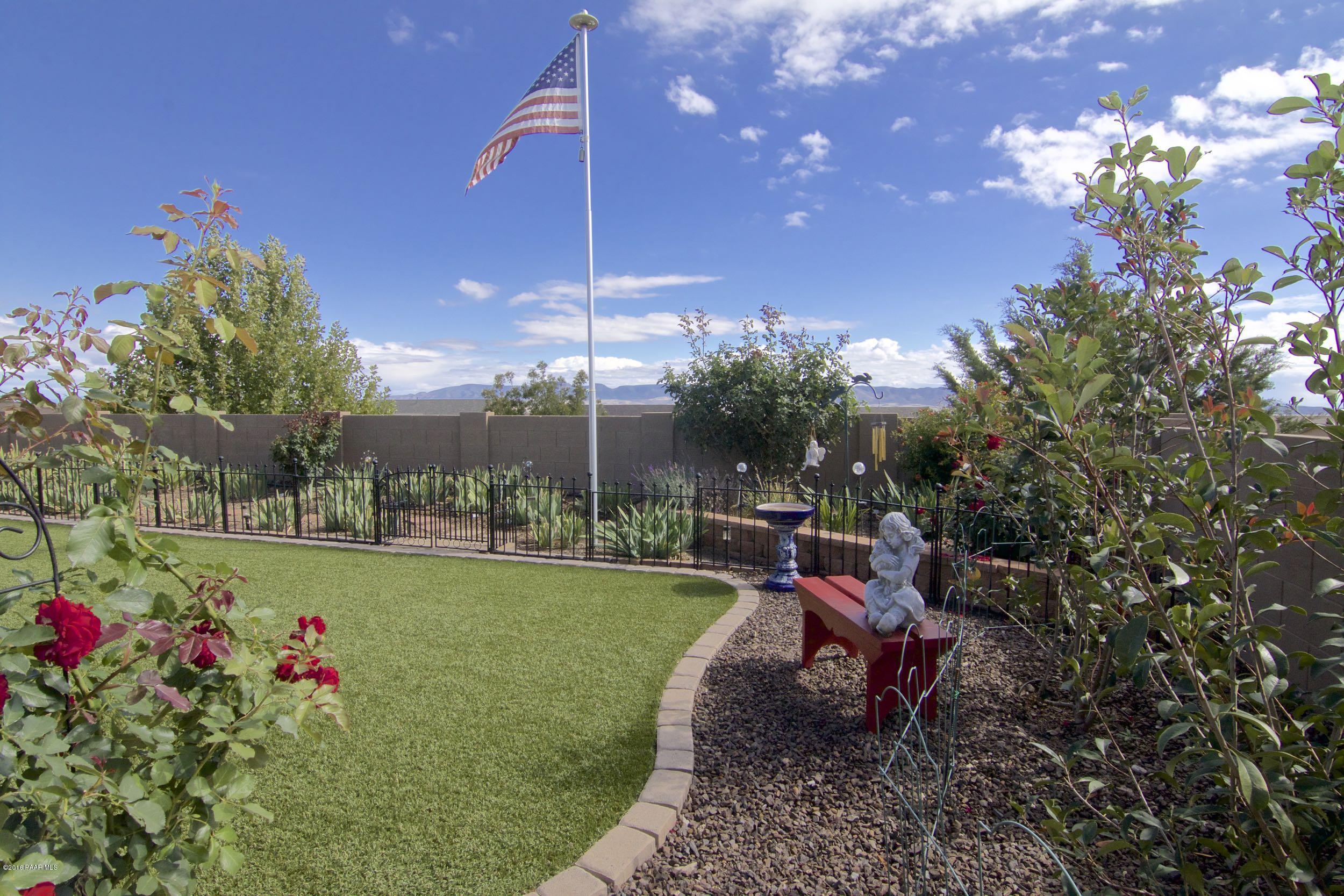 1157 Rusty Nail Road Prescott Valley, AZ 86314 - Photo 25 of 45 a view of a backyard with sitting area and garden