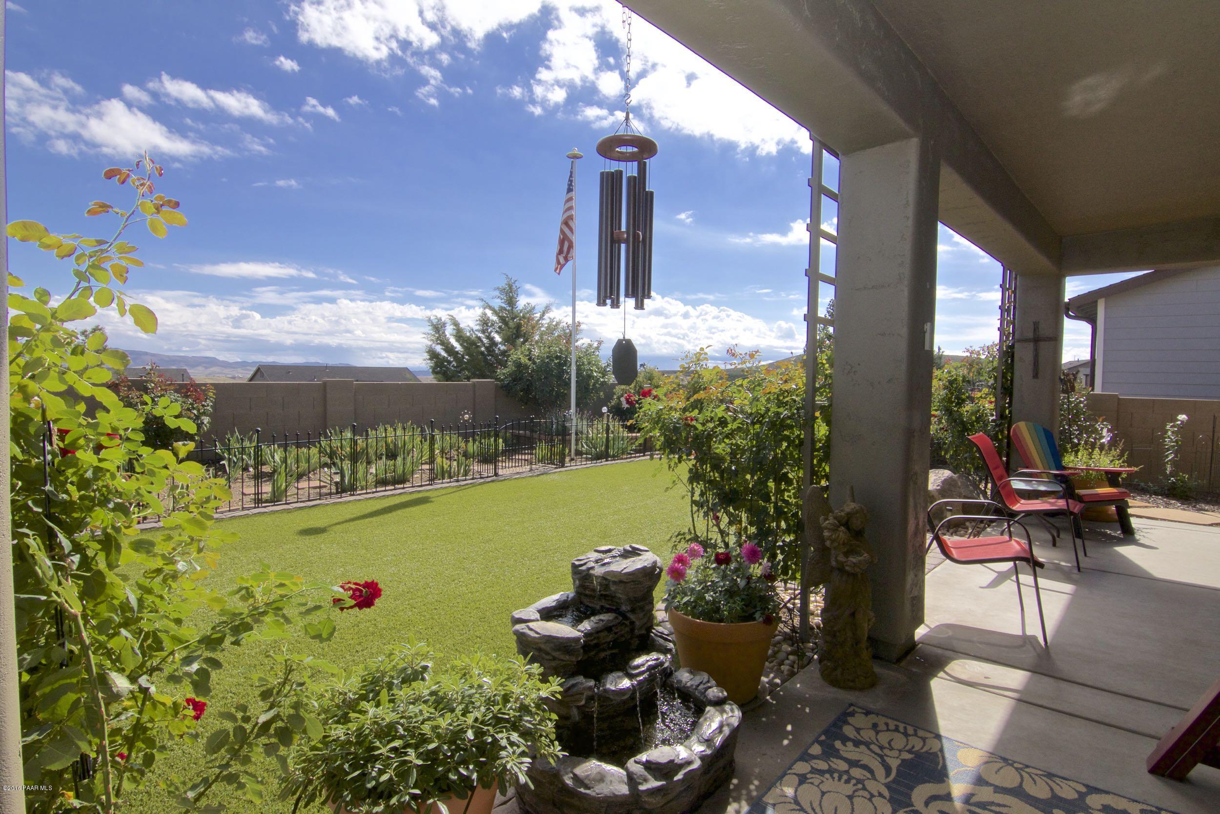 1157 Rusty Nail Road Prescott Valley, AZ 86314 - Photo 28 of 45 a view of a patio with chair and table potted plants
