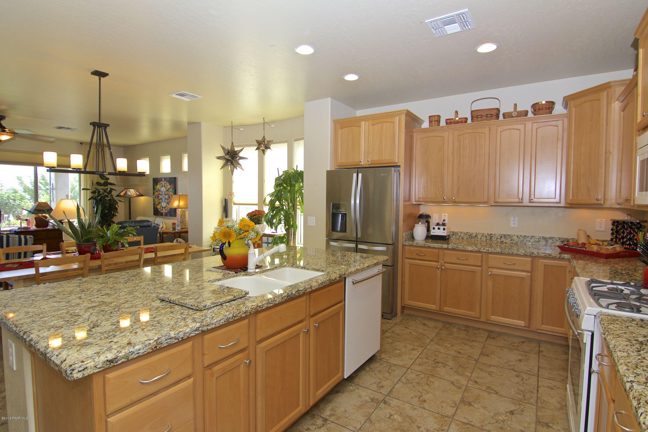 1157 Rusty Nail Road Prescott Valley, AZ 86314 - Photo 6 of 45 a kitchen with stainless steel appliances granite countertop a sink refrigerator and cabinets