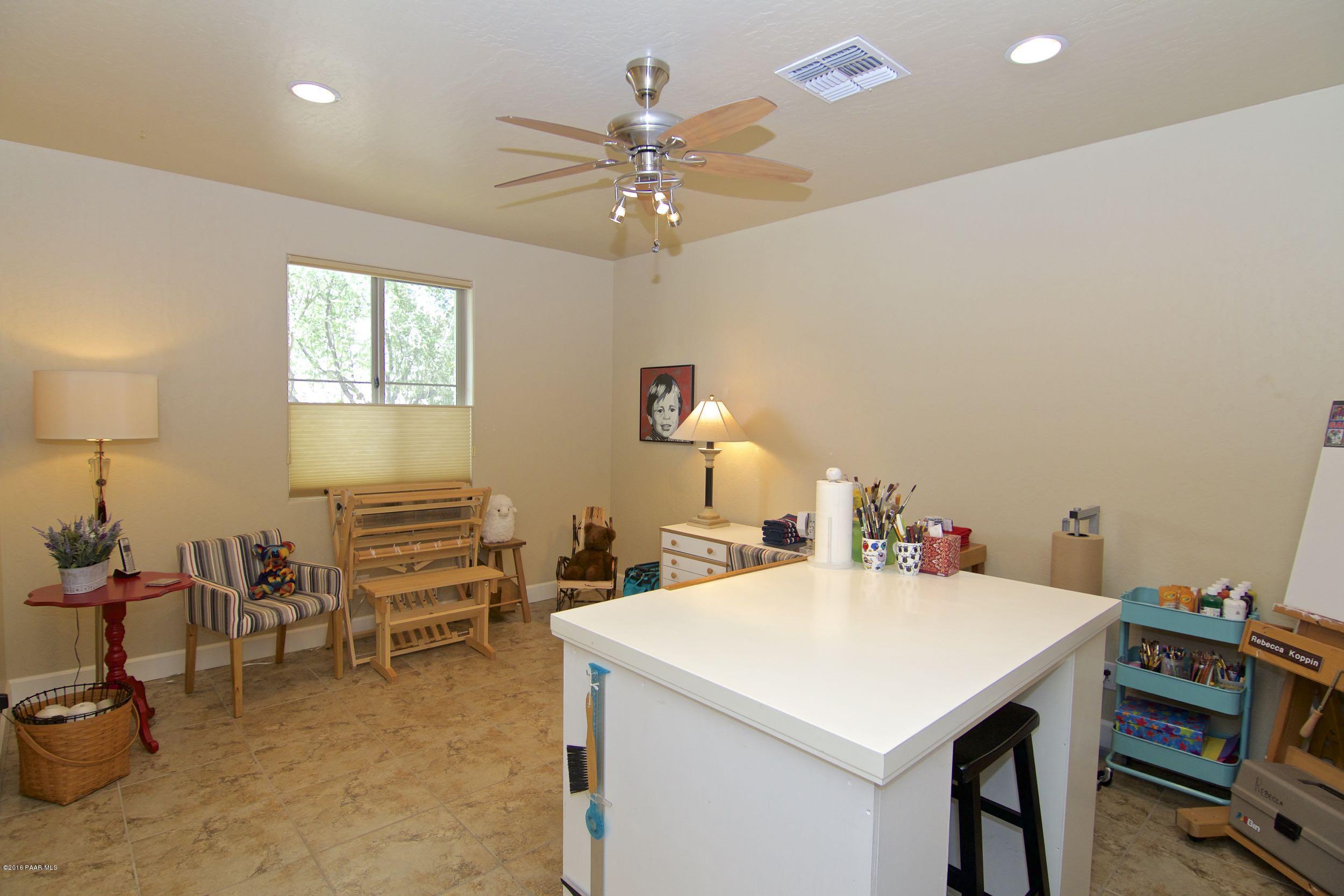 1157 Rusty Nail Road Prescott Valley, AZ 86314 - Photo 10 of 45 a view of a dining room with furniture and a chandelier fan