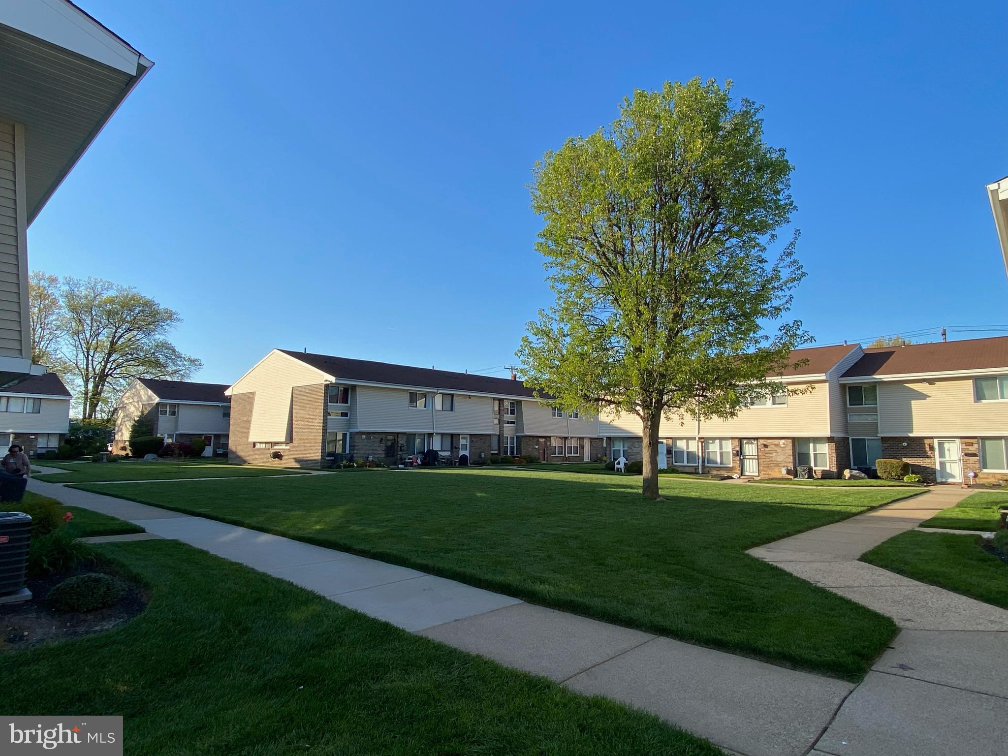 3850 Woodhaven Road, Unit 1012 Philadelphia, PA 19154 - Photo 13 of 16 a front view of a house with a yard
