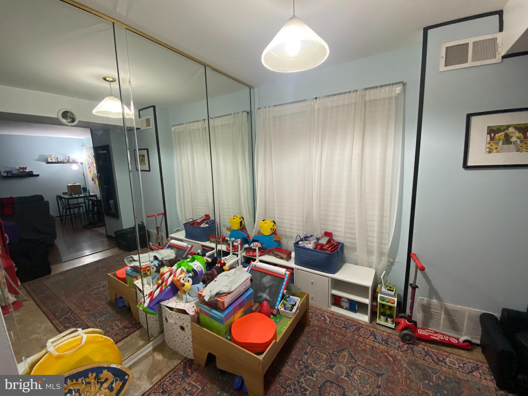 3850 Woodhaven Road, Unit 1012 Philadelphia, PA 19154 - Photo 6 of 16 a living room filled with furniture and a chandelier