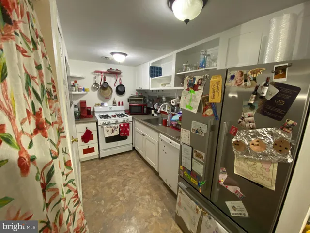 a utility room with cabinets dryer and washer