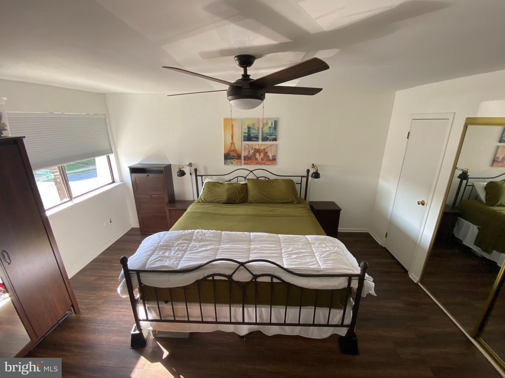 3850 Woodhaven Road, Unit 1012 Philadelphia, PA 19154 - Photo 10 of 16 a bedroom with a bed and wooden floor