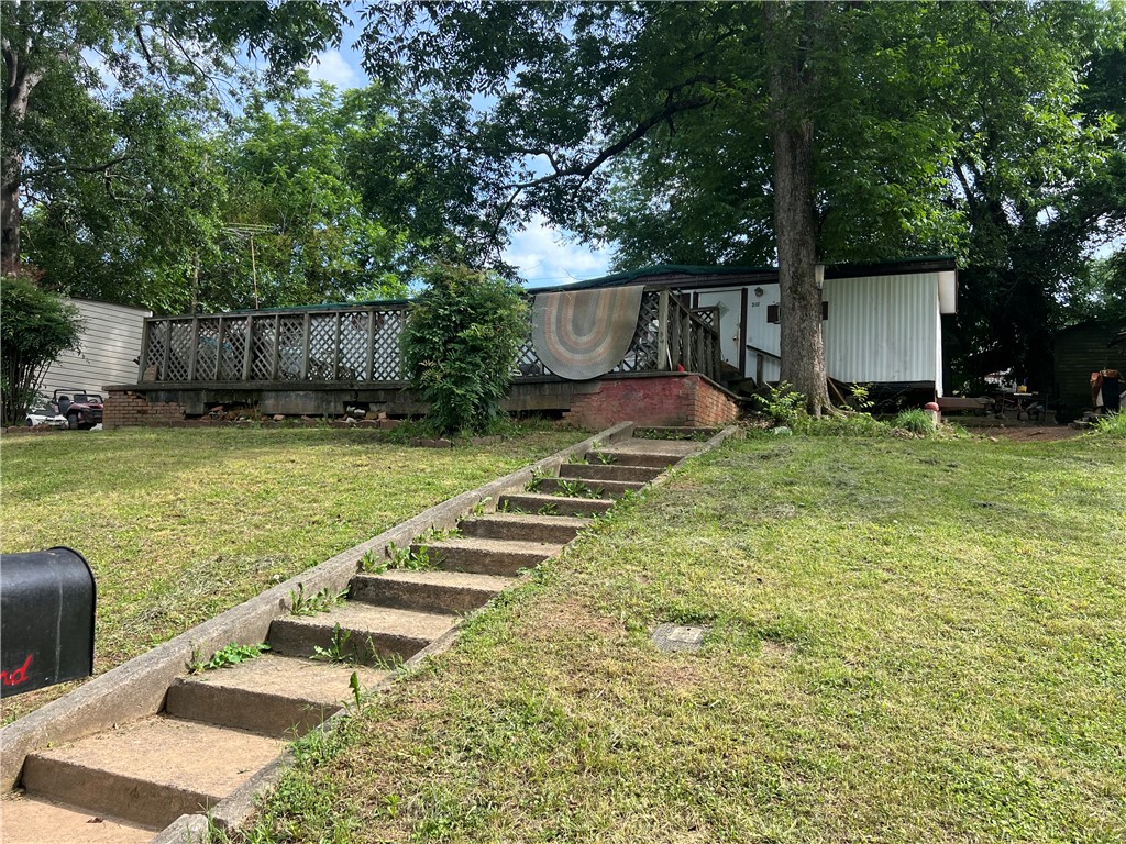 310 Jaynes Street Walhalla, SC 29691 - Photo 1 of 1 A quaint residence nestled among mature trees offers a welcoming elevated deck.