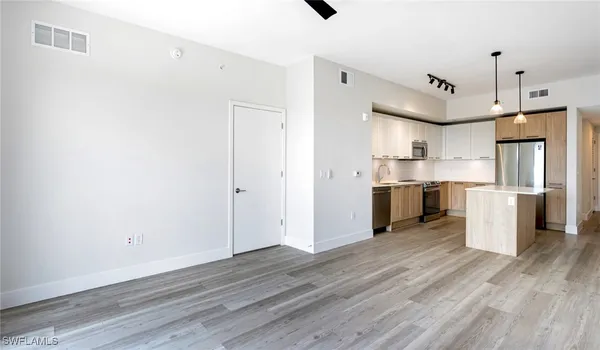 a view of an empty room with glass door