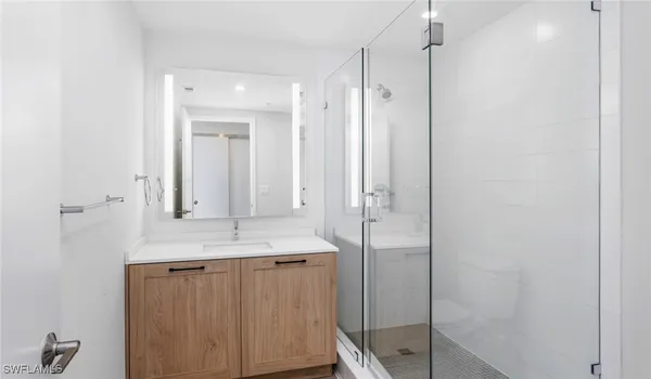 a white toilet sitting next to a bathroom sink