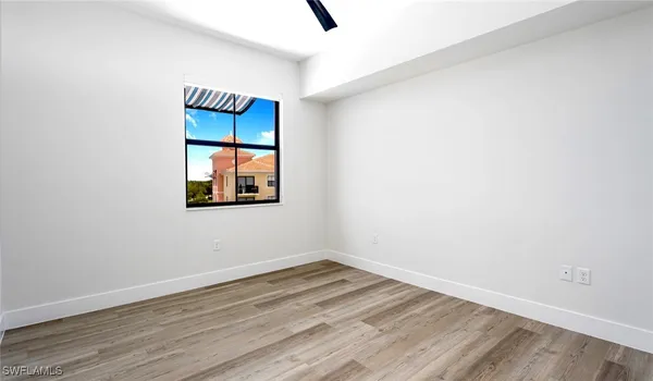 an empty room with wooden floor