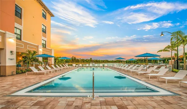 a swimming pool with outdoor seating and yard