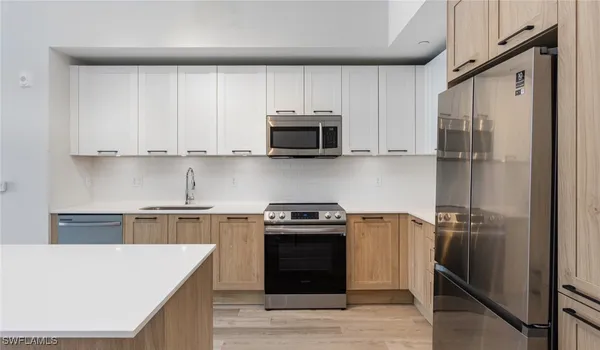 a kitchen with a stove and a refrigerator