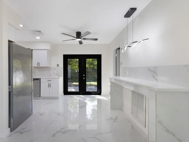 a view of an empty room with a kitchen