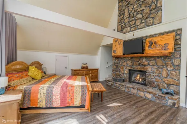 a bedroom with a bed and a fireplace