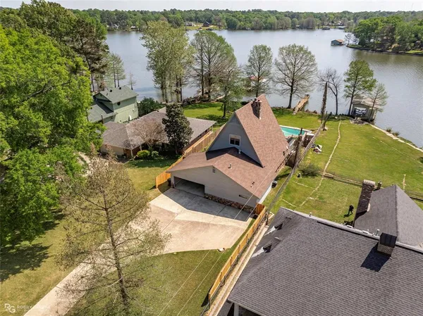 an aerial view of a house with a lake view
