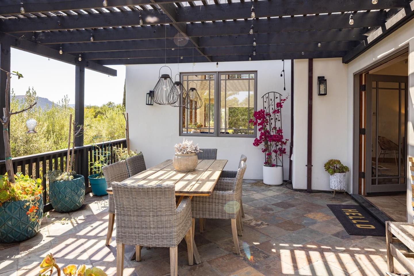 175 Chaparral Road Carmel Valley, CA 93924 - Photo 18 of 40 a outdoor dining space with furniture and front view of a house