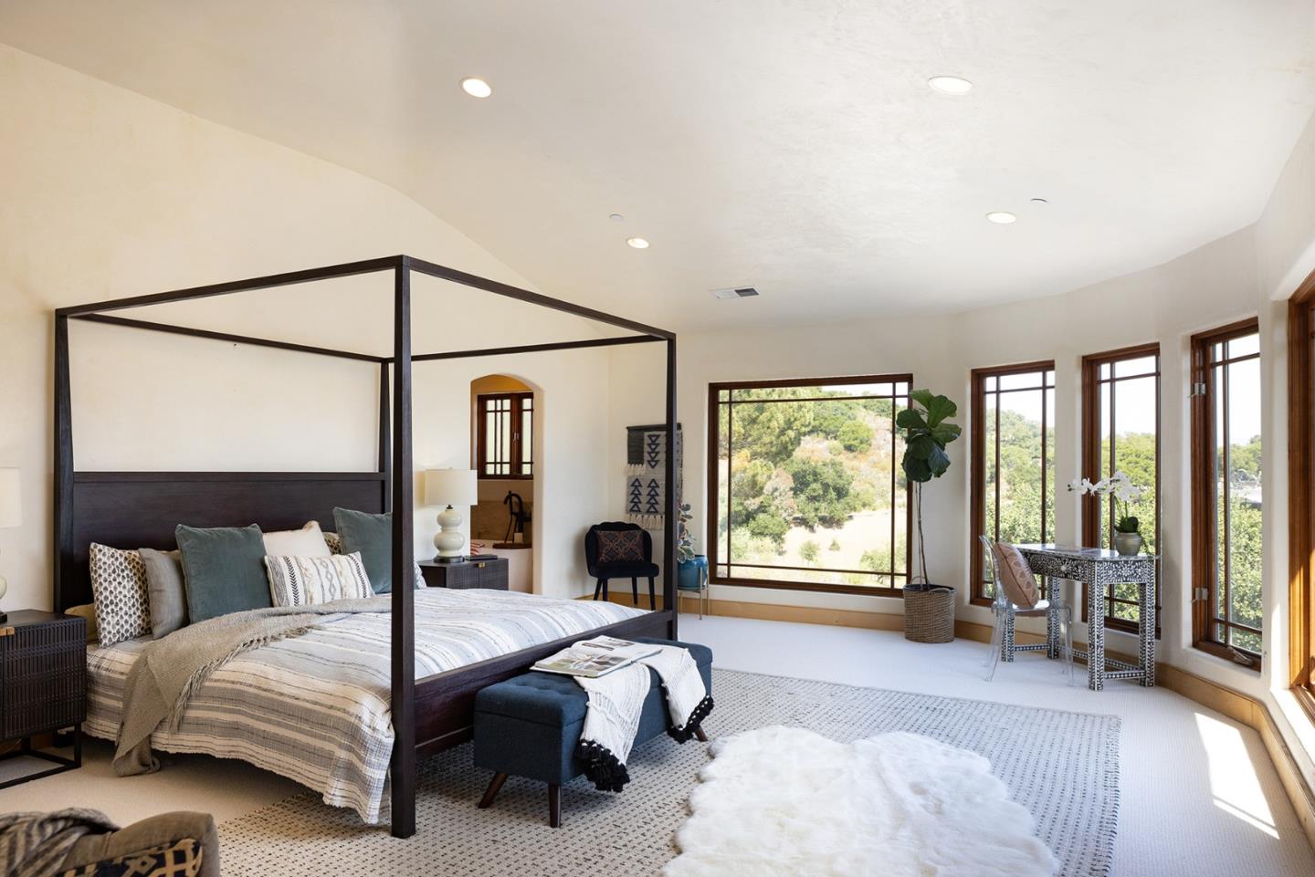 175 Chaparral Road Carmel Valley, CA 93924 - Photo 22 of 40 a bedroom with a bed and large window