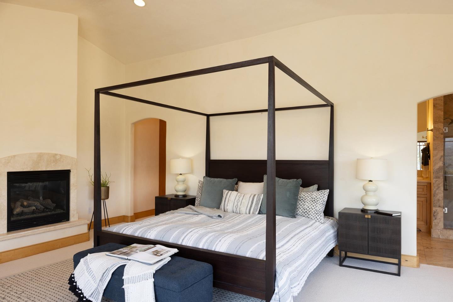 175 Chaparral Road Carmel Valley, CA 93924 - Photo 24 of 40 a bedroom with a bed and a fireplace