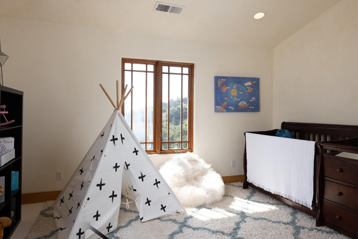 175 Chaparral Road Carmel Valley, CA 93924 - Photo 31 of 40 a bedroom with furniture and a large window