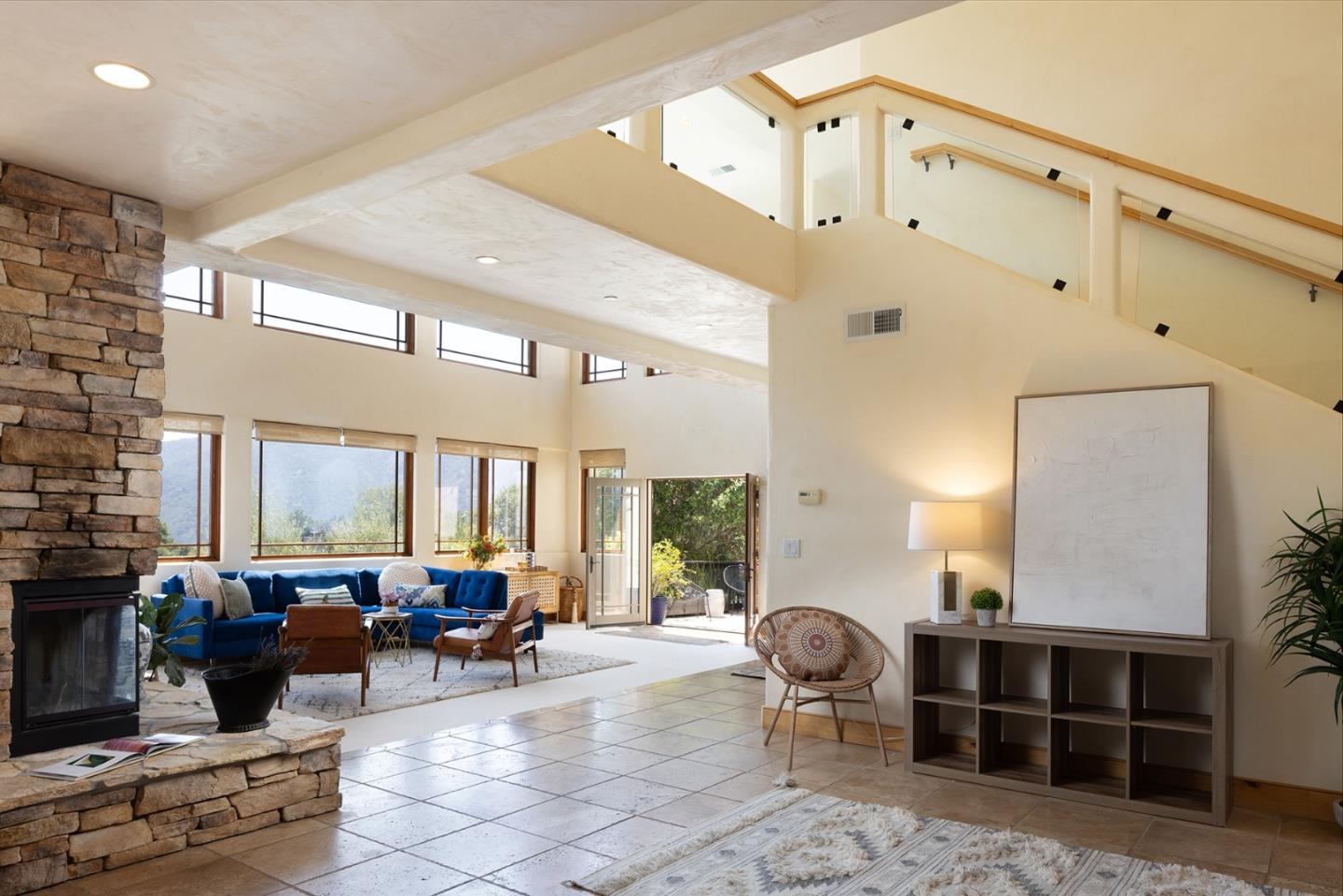 175 Chaparral Road Carmel Valley, CA 93924 - Photo 8 of 40 a living room with furniture windows and a fireplace