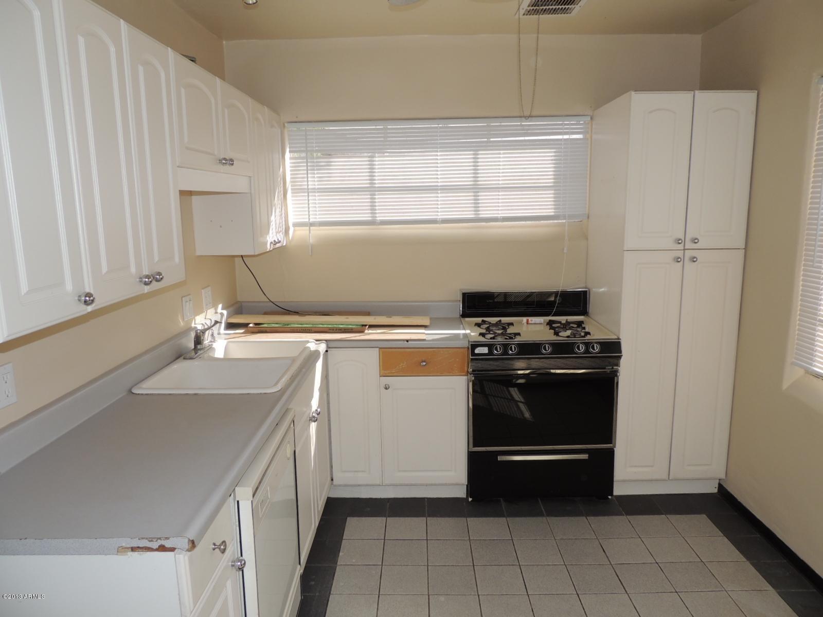 4620 North 10th Place Phoenix, AZ 85014 - Photo 13 of 19 a kitchen with a sink stove and refrigerator