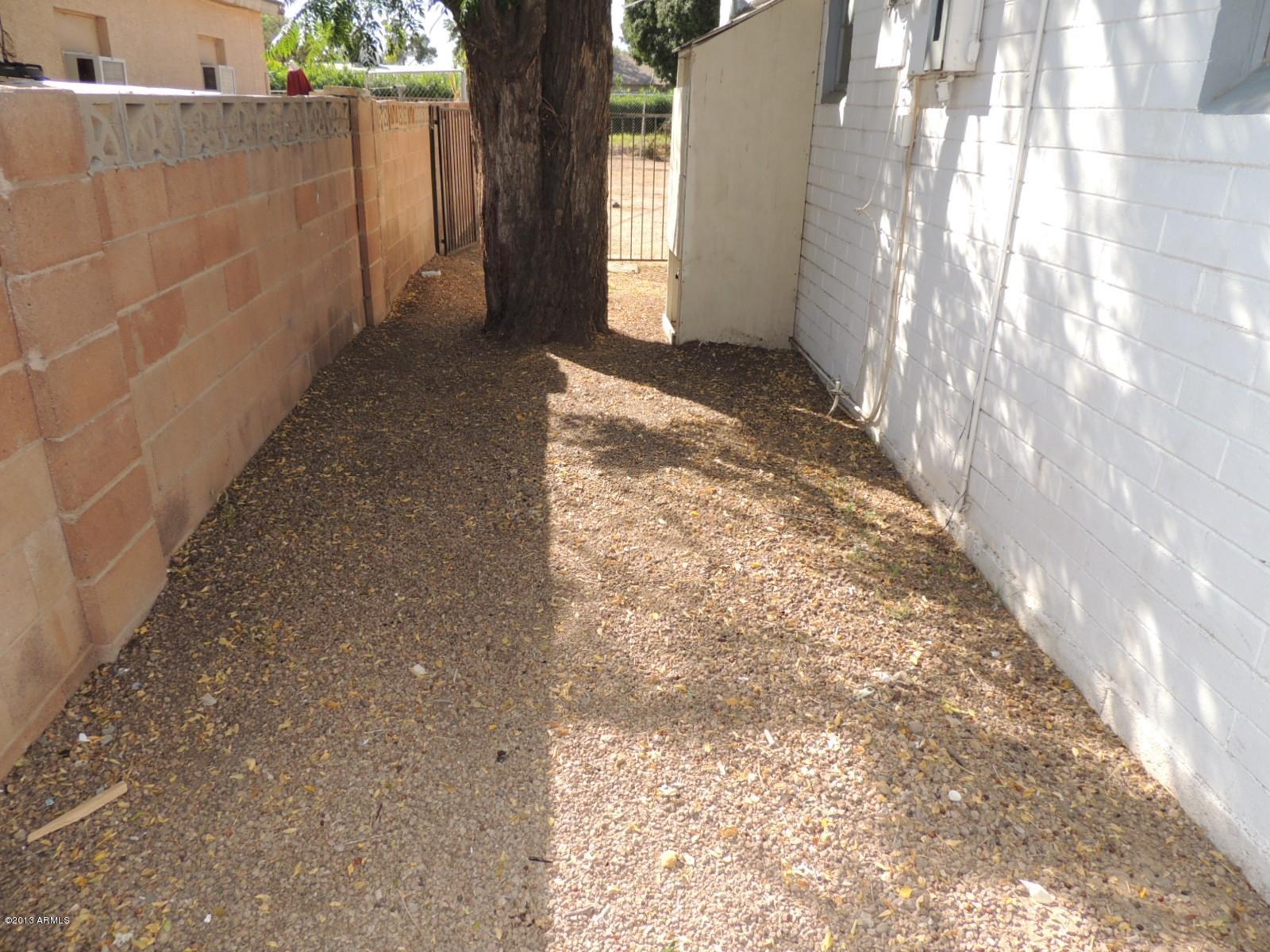 4620 North 10th Place Phoenix, AZ 85014 - Photo 19 of 19 a view of a yard with brick walls