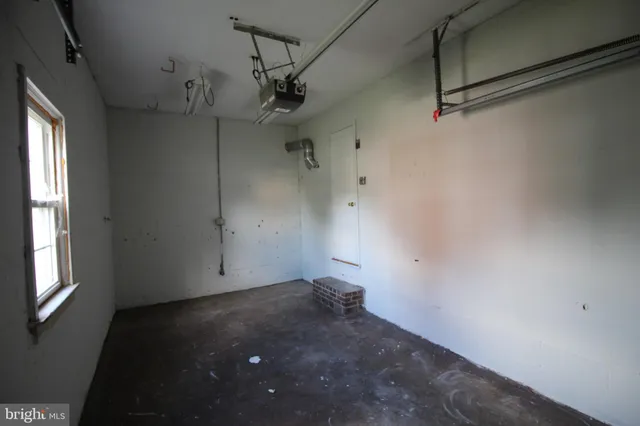 a view of a room with a window and a ceiling fan