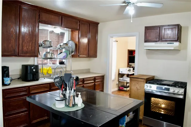 a kitchen with a table chairs and stove