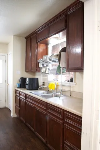 a kitchen with a sink and a wooden cabinets