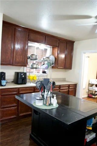 a kitchen with a sink a counter space and cabinets