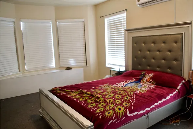 a bed sitting in a bedroom next to a window