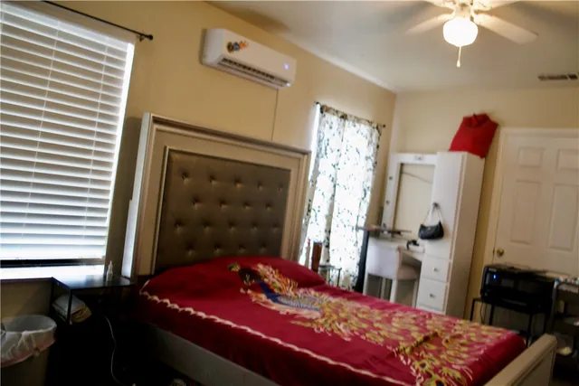 a bedroom with a bed and a dresser