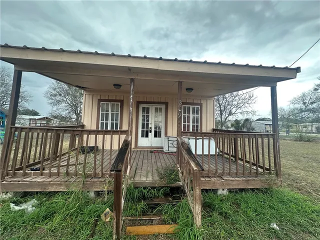 a view of a wooden deck and a yard