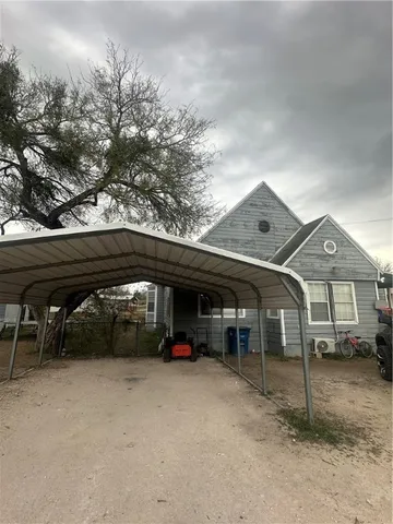 a view of building with car parked