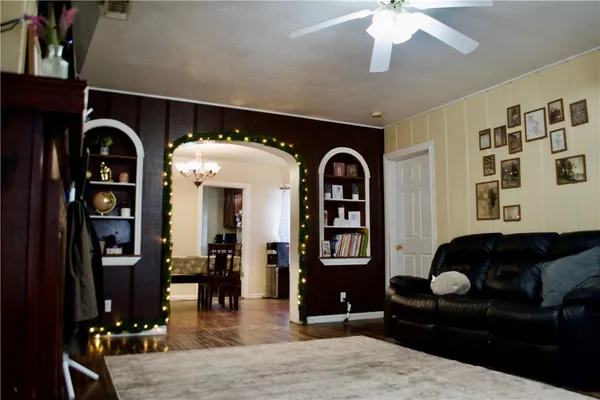 a living room with furniture a rug and potted plant