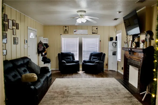 a living room with furniture fireplace and a flat screen tv